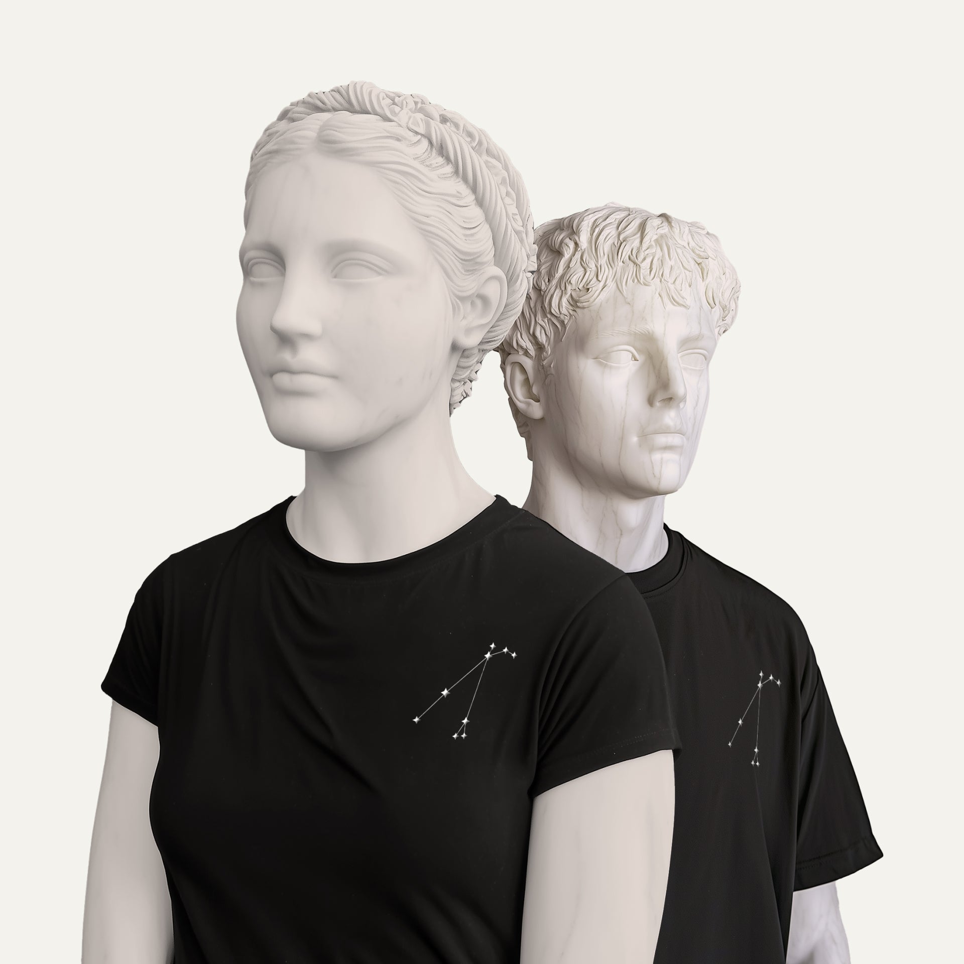 The Constellation Tee modeled on classical bust sculptures, showcasing a minimalist embroidered star sign constellation on the chest of the black t-shirts.